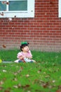 Cute Chinese baby girl wears glasses on the lawn Royalty Free Stock Photo