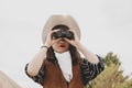 Cute chinese cowgirl while looking at the horizon with binoculars Royalty Free Stock Photo