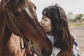 Cute chinese cowgirl while taking care of her horse Royalty Free Stock Photo