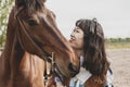 Cute chinese cowgirl while taking care of her horse Royalty Free Stock Photo