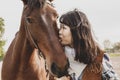 Cute chinese cowgirl while taking care of her horse Royalty Free Stock Photo