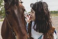 Cute chinese cowgirl while taking care of her horse Royalty Free Stock Photo