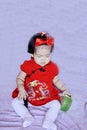 Cute Chinese little baby in red cheongsam have fun Royalty Free Stock Photo