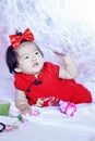 Cute Chinese little baby in red cheongsam have fun Royalty Free Stock Photo