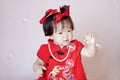 Cute Chinese little baby in red cheongsam play soap bubbles Royalty Free Stock Photo