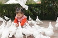 Chinese kid feeding pigeon Royalty Free Stock Photo