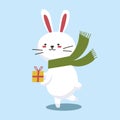 Cute Christmas bunny. Flat cartoon illustration of a little white rabbit holding a gift on a blue background. Vector 10 Royalty Free Stock Photo