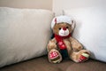 Christmas Teddy bear sits on the couch Royalty Free Stock Photo