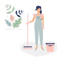 Cute cleaner woman in blue overalls like a cinderella with sweeping brush and bucket.Decorated beautiful leaves and branches.