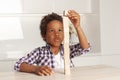 Cute clever child small boy playing and building a tower of wooden blocks at home Royalty Free Stock Photo