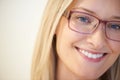 Cute and clever. Closeup of a pretty young woman wearing glasses and smiling. Royalty Free Stock Photo