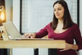 Cute clever secretary reading an important email and smiling