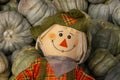 Cute cloth Halloween scarecrow figure with big smile against Cinderella pumpkin background