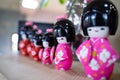 Cute, colorful Japanese-style ceramic dolls are lined up on the table to decorate your home Royalty Free Stock Photo