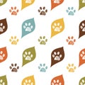Cute colorful leaves and doodle paw prints. Fabric design seamless nature pattern Royalty Free Stock Photo