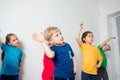 Kids doing stretching exercises before gymnastic training Royalty Free Stock Photo