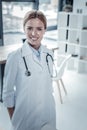 Cute confident nurse standing and smiling. Royalty Free Stock Photo