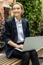 Cute contented young woman with a laptop