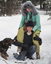 Cute couple having fun with their dog in winter forest Royalty Free Stock Photo