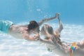 Cute couple kissing underwater in the swimming pool Royalty Free Stock Photo