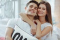 Cute couple in love spending time together.Woman embracing her partner in bed. Celebrating Saint Valentine`s day Royalty Free Stock Photo