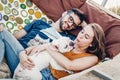 Cute couple lying in a hammock with a dog, funny white bulldog relaxing with a hipster young family on a beach, family portrait Royalty Free Stock Photo