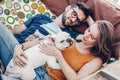 Cute couple lying in a hammock with a dog, funny white bulldog relaxing with a hipster young family on a beach, family portrait Royalty Free Stock Photo