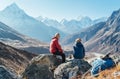 Cute Couple resting on the Everest Base Camp trekking route near Dughla 4620m. Man smiling to woman.Backpackers left Backpacks and