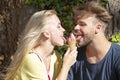 Cute couple romantic dating and eating ice cream. Young pair sharing icecream. True love. Man with woman in relations. Royalty Free Stock Photo