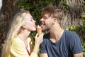 Cute couple romantic dating and eating ice cream. Young pair sharing icecream. True love. Man with woman in relations. Royalty Free Stock Photo