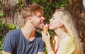 Cute couple romantic dating and eating ice cream. Young pair sharing icecream. True love. Man with woman in relations. Royalty Free Stock Photo