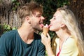 Cute couple romantic dating and eating ice cream. Young pair sharing icecream. True love. Man with woman in relations. Royalty Free Stock Photo