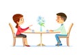 Cute couple sitting at table, drinking tea or coffee and talking. Young funny man and woman at cafe on date. Dialog or Royalty Free Stock Photo