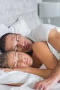 Cute couple sleeping and spooning in bed Royalty Free Stock Photo