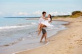 Cute couple of sweethearts have fun on the sea coast