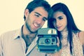 Cute couple taking photos with instant old camera Royalty Free Stock Photo