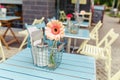 cozy outdoor cafe, with gerbera flower on the table Royalty Free Stock Photo