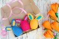 Cute creative photo with eggs as the Easter Bunny and beautiful flowers on a wooden background.