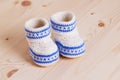 Cute Crochet baby booties on wooden background Royalty Free Stock Photo