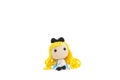 Cute crochet doll. A cute crochet doll with blond hair and apron isolated on a white background