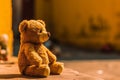 Ai Generative Teddy bear sitting on the floor in front of a yellow wall