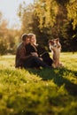 Cute cuple with dog border collie on green field in park under tree in sunshine Royalty Free Stock Photo