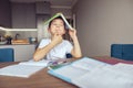 Cute curious Caucasian small schoolboy holding textbook over head with guessing face. Royalty Free Stock Photo