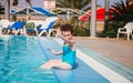 Cute curly baby waving hand from the pool Royalty Free Stock Photo