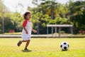 Cute curly little boy playing football. Kids play Royalty Free Stock Photo