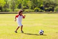 Cute curly little boy playing football. Kids play Royalty Free Stock Photo
