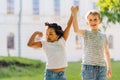 Smiling and showing their muscles outdoor in park on background.