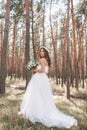 A cute curly woman in a white wedding dress