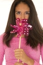 Cute dark complected teen girl holding a toy windmill