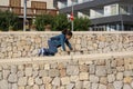 Cute darkhaired girl balances on stone wall on a sunny day Royalty Free Stock Photo